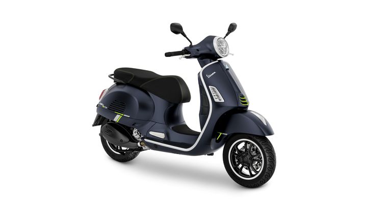 A dark blue scooter with a sleek design, featuring black accents and green detailing, showcasing a modern headlight and dual-tone seat.