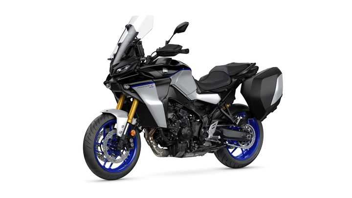 A sleek, modern motorcycle with a silver and black body, golden front forks, blue wheels, and side panniers, positioned at an angle on a white background.