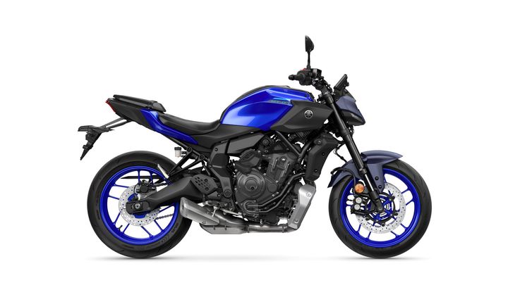 A blue and black Yamaha MT-07 motorcycle is displayed from the side, showcasing its sleek design, sporty frame, and distinctive blue wheels.