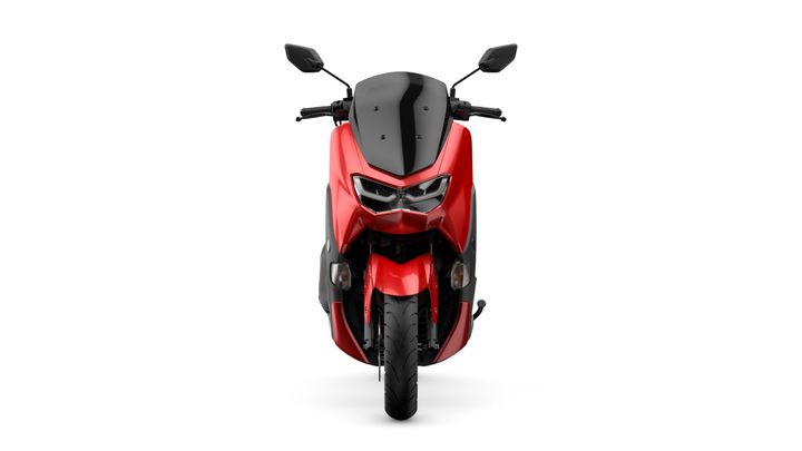 A red and black motorcycle facing forward, showcasing its sleek design, dual headlights, and prominent front wheel.