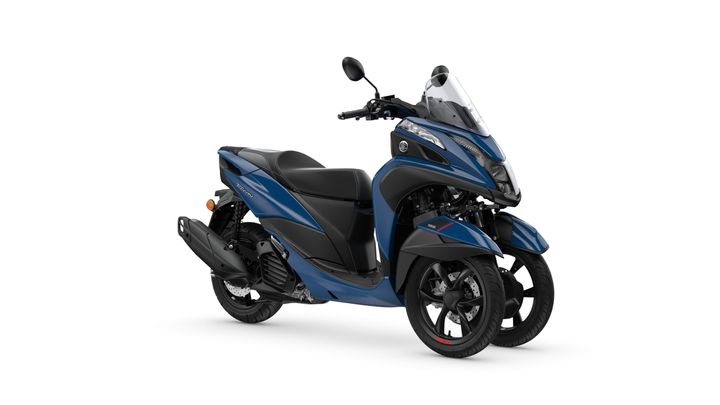 A blue three-wheeled scooter featuring a sleek design, with a windshield, comfortable seat, and dual front wheels.