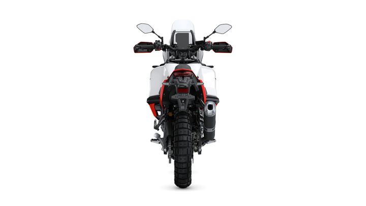 A rear view of a modern motorcycle with a predominantly white body, featuring red accents on the side panels and tail, designed for off-road use, showcasing rugged tires and dual exhaust.