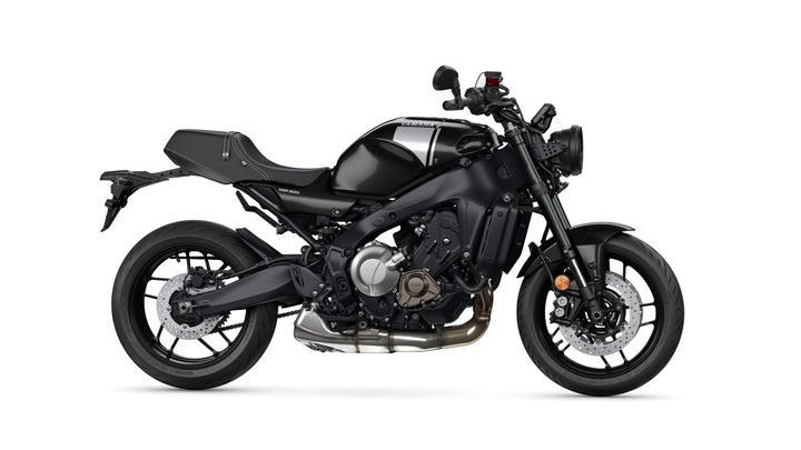 A sleek black Yamaha XSR 700 motorcycle positioned on a white background, showcasing its modern design, sporty features, and distinctive retro styling elements.