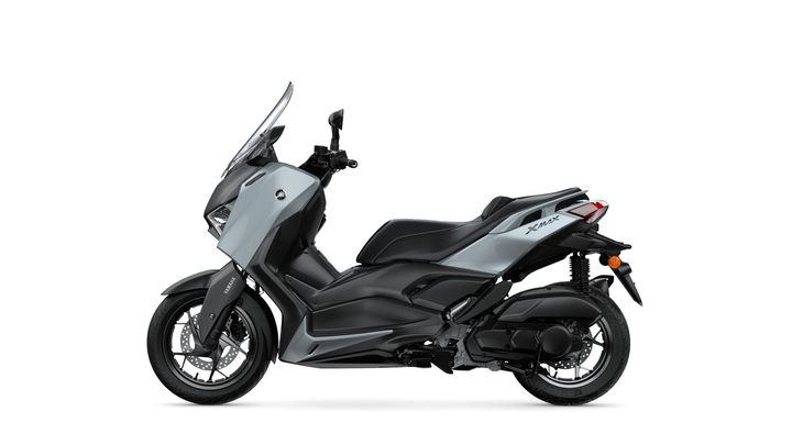 A side view of a sleek, modern Yamaha XMAX scooter in grey and black, showcasing its streamlined design and features.