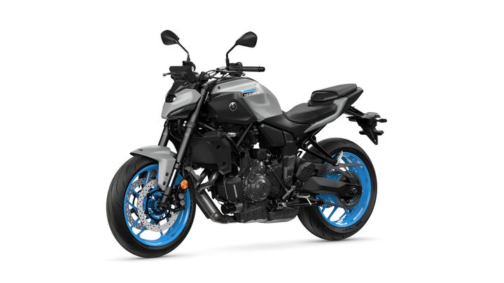 A Yamaha MT-09 motorcycle with a sleek gray body and vibrant blue wheels, positioned at a slight angle to showcase its design.