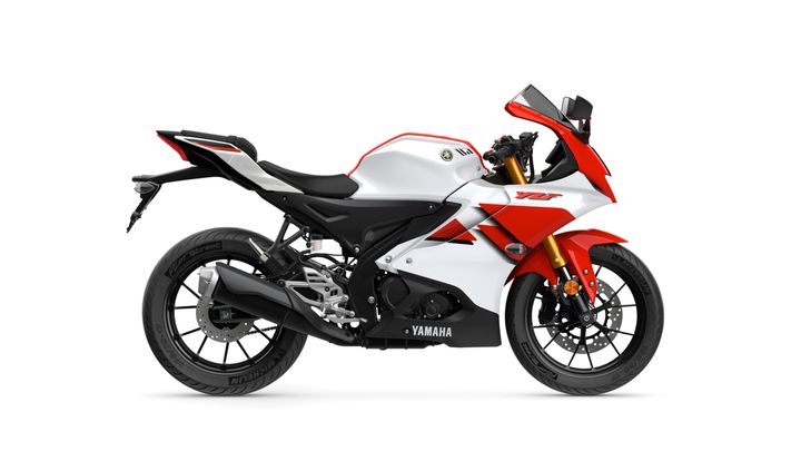 A sleek, modern Yamaha sports motorcycle in white and red, showcasing a streamlined design and sporty aesthetics, viewed from the side.