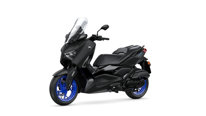A sleek black Yamaha scooter with blue wheels and a tall windscreen, positioned at an angle to showcase its modern design and features.