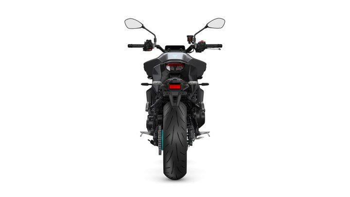 Black motorcycle viewed from the rear, showcasing its sleek tail design, large rear tire, and handlebars with controls.