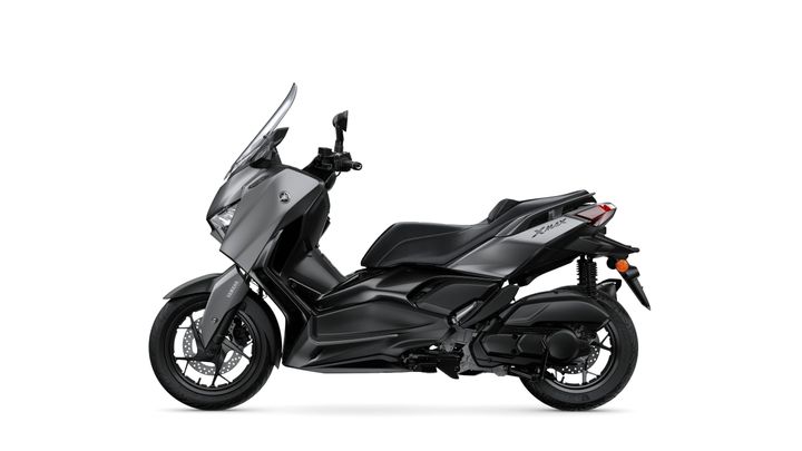 A sleek, modern Yamaha XMAX scooter in a matte gray finish, shown from the side with a prominent windshield and a low-profile seat.