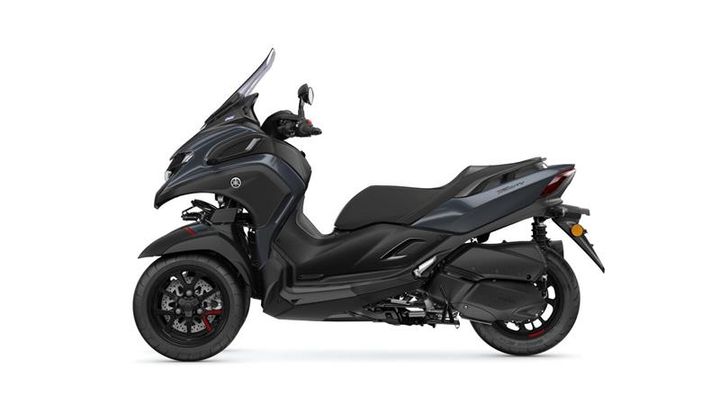 A black scooter with a streamlined body, featuring a tall windshield, front fender, and a sleek design, positioned on a white background.