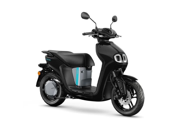 A sleek black electric scooter with a distinctive design, featuring two circular front lights and a light blue battery compartment on the side. The scooter has a single seat and modern dual-tone wheels, positioned on a white background.