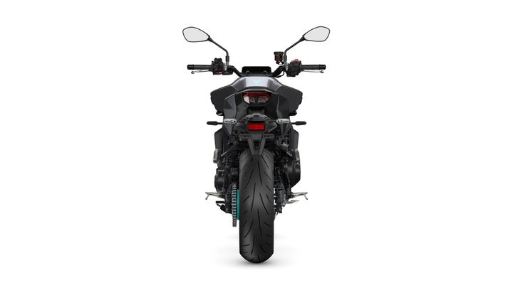 A rear view of a sleek, black motorcycle showcasing its wide rear tire and modern design features.