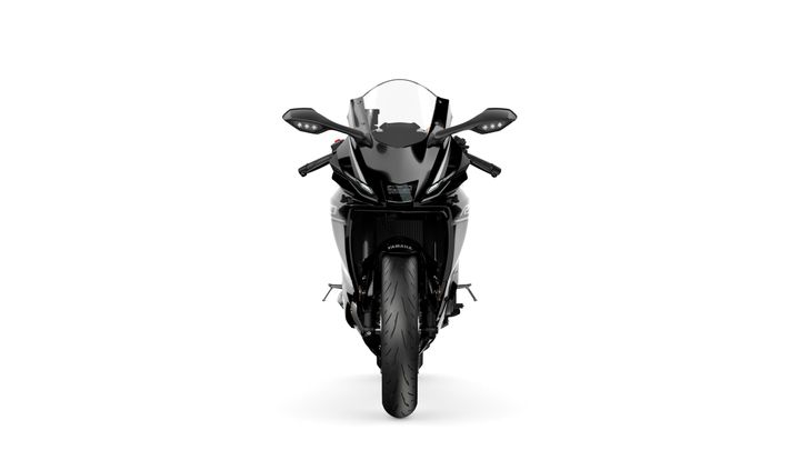 A black motorcycle viewed from the front, featuring a sleek design with a windscreen, dual headlights, and prominent mirrors. The front tire is clearly visible, set against a white background.
