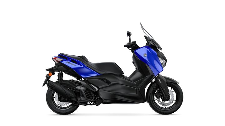 A blue scooter with a sleek design positioned on a white background, featuring a prominent front windscreen and a sporty black seat.