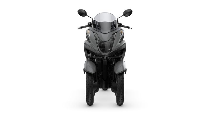 A front view of a sleek, modern motorcycle featuring two front wheels, a tinted windshield, and futuristic design elements in a matte gray finish against a white background.