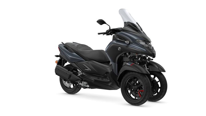 A sleek black Yamaha three-wheeled scooter with a windshield and sporty design, parked against a plain white background.
