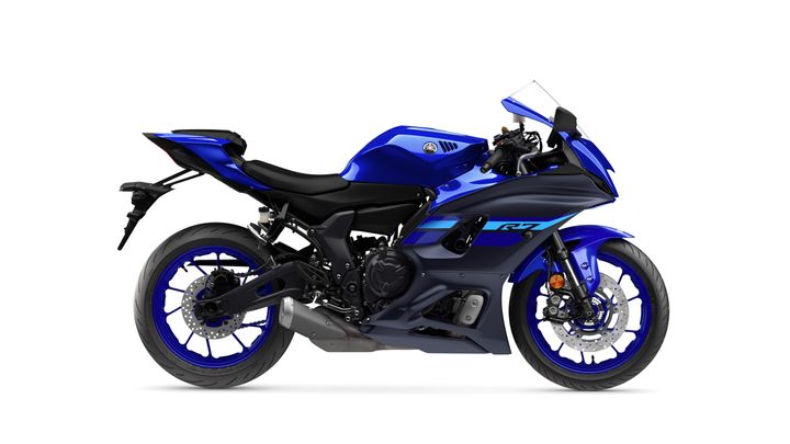 A sleek blue Yamaha R7 motorcycle shown from the right side, highlighting its aerodynamic design, sporty seat, and modern features.
