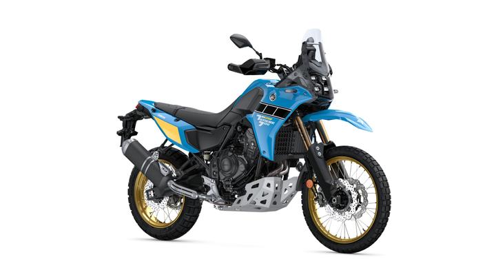 Yamaha Ténéré 700 Rally A blue and black adventure motorcycle with gold rims and off-road tires, featuring a robust frame, dual-sport styling, and a large windscreen, positioned at an angle.