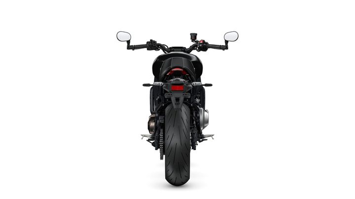 A rear view of a motorcycle featuring a black frame, distinctive rear wheel, and handlebars with mirrors. The background is plain white, emphasizing the motorcycle's design.