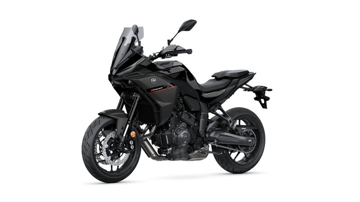 A sleek black motorcycle with a sporty design, featuring a tall windscreen, sporty seat, and prominent front and rear tires.
