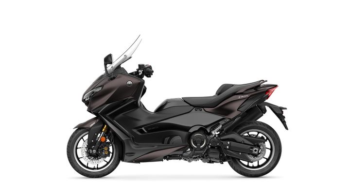 A sleek black Yamaha TMAX scooter viewed from the side, showcasing its sporty design and features, including a fairing, windshield, and dual exhaust.