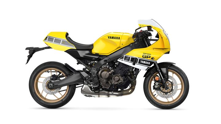 A vibrant yellow Yamaha motorcycle with sleek lines, featuring a black chassis, gold wheels, and a sporty fairing design.