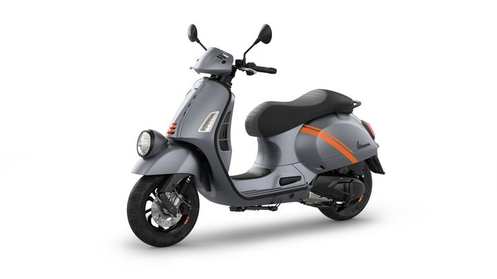 A sleek gray scooter with orange stripes, featuring a round headlight, black seat, and modern design details, positioned on a white background.