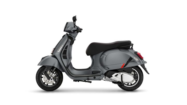 A sleek gray scooter with a retro design, featuring a comfortable seat, visible handlebars, and distinctive tire details, set against a plain white background.