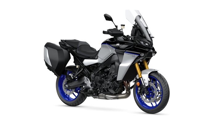 A sleek black and silver motorcycle with blue accents and a tall windshield, featuring a dual-side pannier on the rear, positioned at a slight angle on a white background.