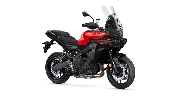 Yamaha 2025 Tracer 9 A sleek red and black Yamaha motorcycle, featuring a modern design with a large windscreen, comfortable seating, and sporty wheels, displayed against a white background.