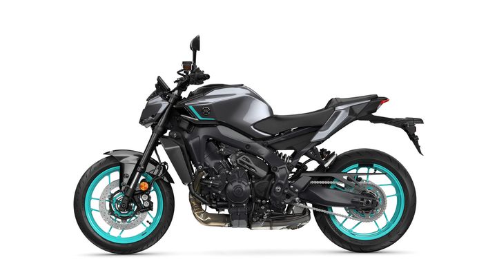 A sleek gray motorcycle with turquoise accents, featuring a sporty design, visible engine details, and unique wheel styling, viewed from the side.