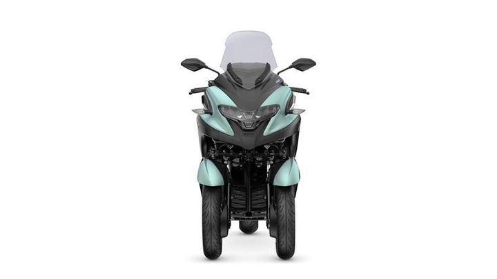 Front view of a teal and black three-wheeled motorcycle with a transparent windscreen.