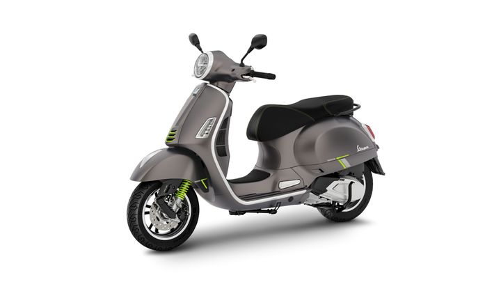 A sleek, modern scooter in a gray finish with green accents, featuring a comfortable seat, retro-style headlight, and a stylish design.