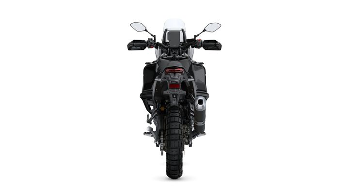 A rear view of a black adventure motorcycle displaying its large rear tire, sleek bodywork, and mounted mirrors, set against a plain white background.