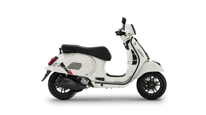 A white scooter with black accents, featuring a comfortable seat, stylish design, and modern detailing, displayed on a plain background.