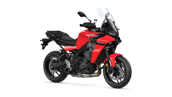 Yamaha 2024 Tracer 9 A red motorcycle with a black seat and detailing, featuring a windshield and sporty design, positioned on a white background.