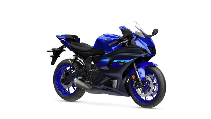 A blue Yamaha motorcycle, model R7, is positioned at an angle showcasing its sleek design, aerodynamic fairing, and sporty styling.