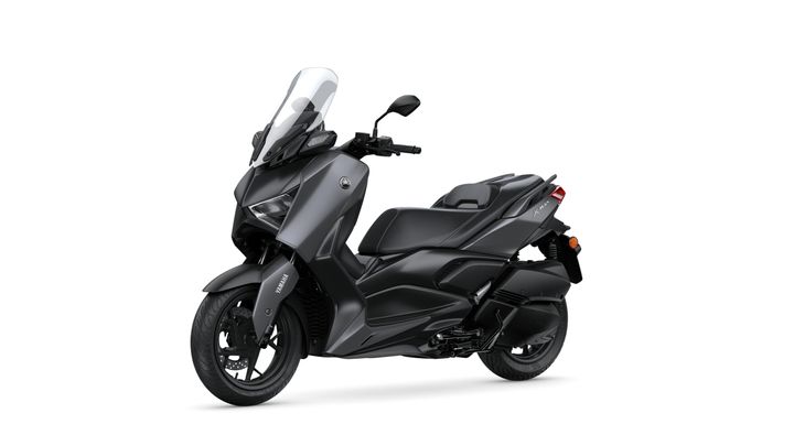 A sleek, modern gray scooter with a windshield and sporty design, parked against a white background.