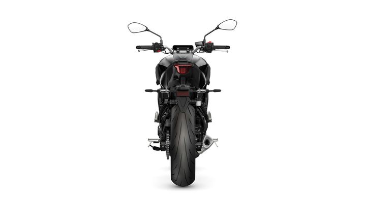 A sleek black motorcycle viewed from the rear, showcasing its large rear tire, rear lights, and handlebars. The background is plain white, emphasizing the bike's design.