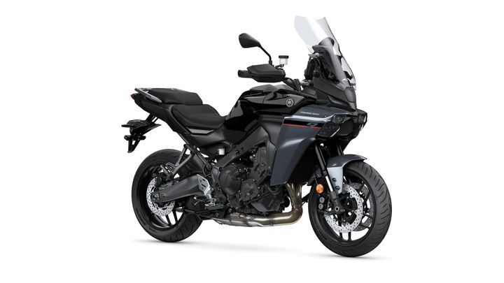 A sleek black Yamaha motorcycle with modern design features, including a tall windscreen, sporty fairings, and a rear luggage rack, positioned at a slight angle against a white background.