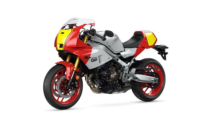 A sleek, modern sports motorcycle with a predominantly silver body, accented by red and yellow details, showcasing an aggressive design and high-performance features.