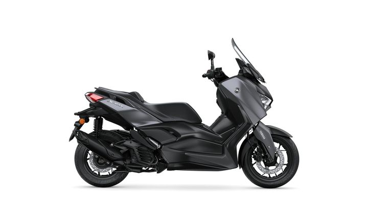 A sleek black Yamaha X-Max scooter viewed from the side, showcasing its modern design, large windshield, and sporty contours.