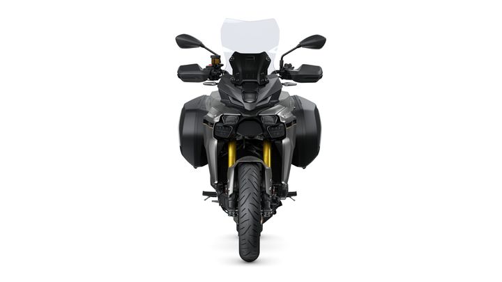 Front view of a modern motorcycle featuring a dual headlight design, tall windshield, and side panniers, set against a white background.