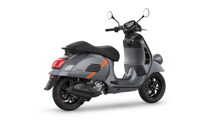 A sleek gray scooter with orange accents, shown from the rear angle, highlighting its rounded design and distinctive rear lights.
