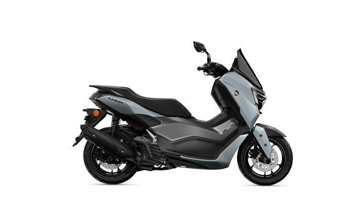 A side view of a sleek, modern scooter in a light gray color with black accents, featuring a prominent windscreen, comfortable seat, and stylish design elements.