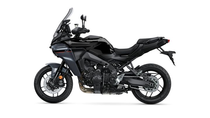 A sleek black motorcycle with a sporty design, featuring a tall windshield, adjustable mirrors, and a low-slung seat, positioned against a white background.