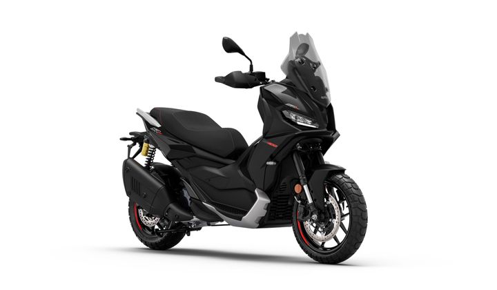 A sleek black scooter with a modern design, featuring a windscreen, dual headlights, and sporty accents, positioned at an angle to showcase its profile and prominent wheels.