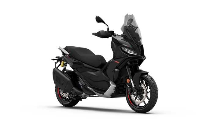 A sleek black scooter with a modern design, featuring a windscreen, dual headlights, and sporty accents, positioned at an angle to showcase its profile and prominent wheels.