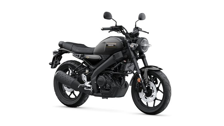 A black Yamaha motorcycle with a retro design, featuring a round headlight, flat seat, and modern accents, positioned at a slight angle against a white background.