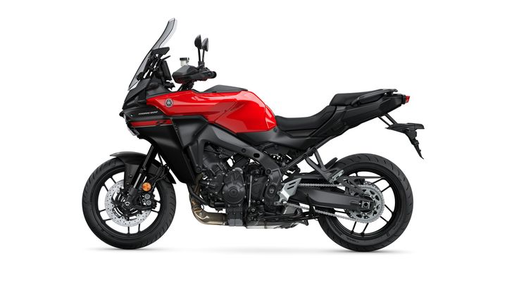 A red and black sport touring motorcycle with a sleek design, featuring a large windshield and advanced bodywork, positioned against a plain white background.